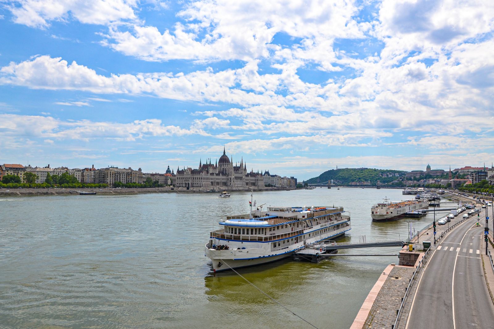 Passenger riverboats moored on the Danube in Budapest with the Parliament on the far bank, a city at the heart of many river cruise deals